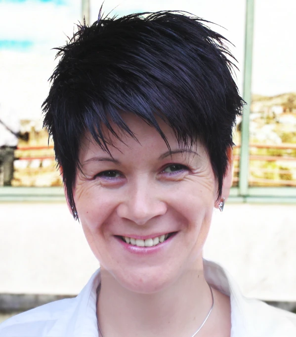 an attractive young lady with short black hair and necklace