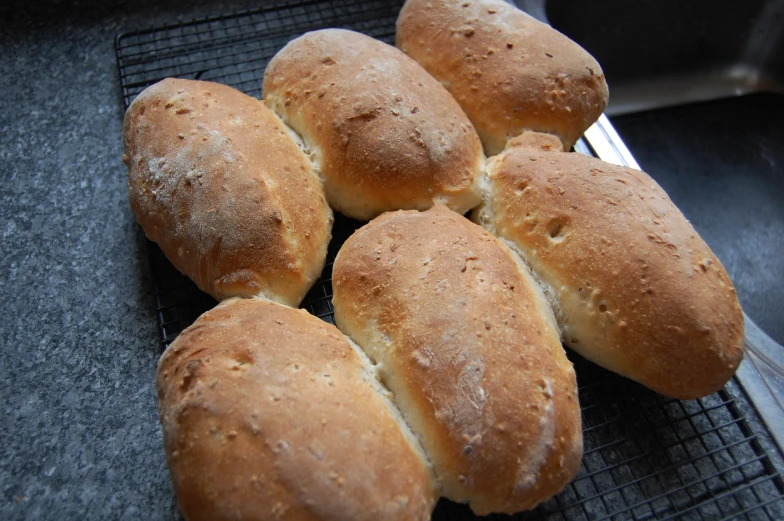 a bunch of buns that are on a grill