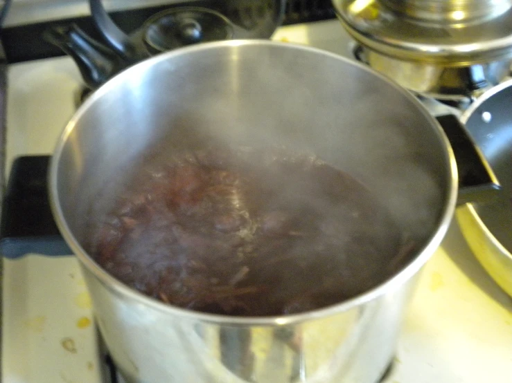 a pot with a red substance in it is sitting on the stove