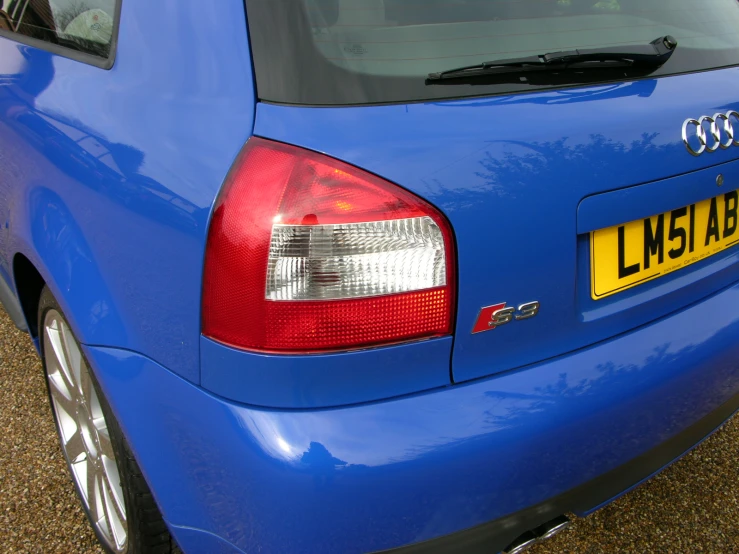 the rear end of an automobile that is blue