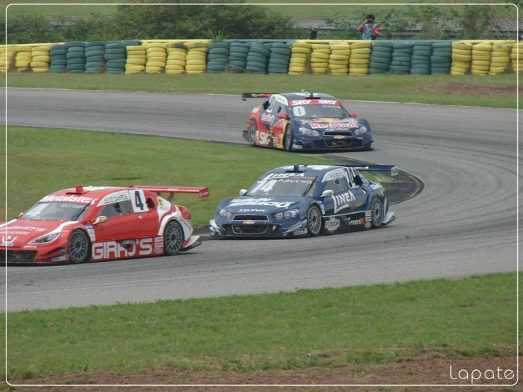 a couple of cars racing down a track