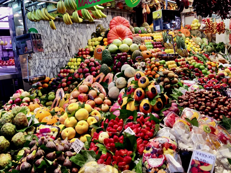 a fruit stand with various fruits and vegetables