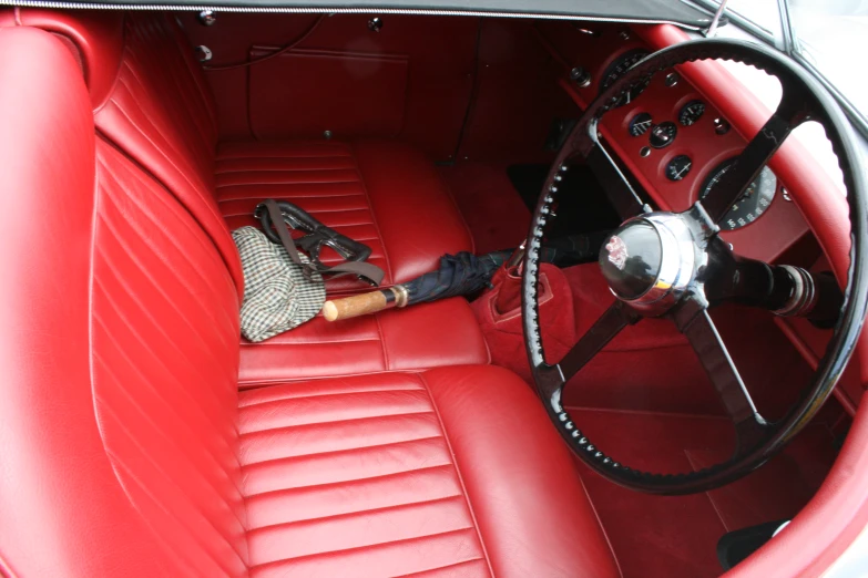 the steering wheel and center console of a red car