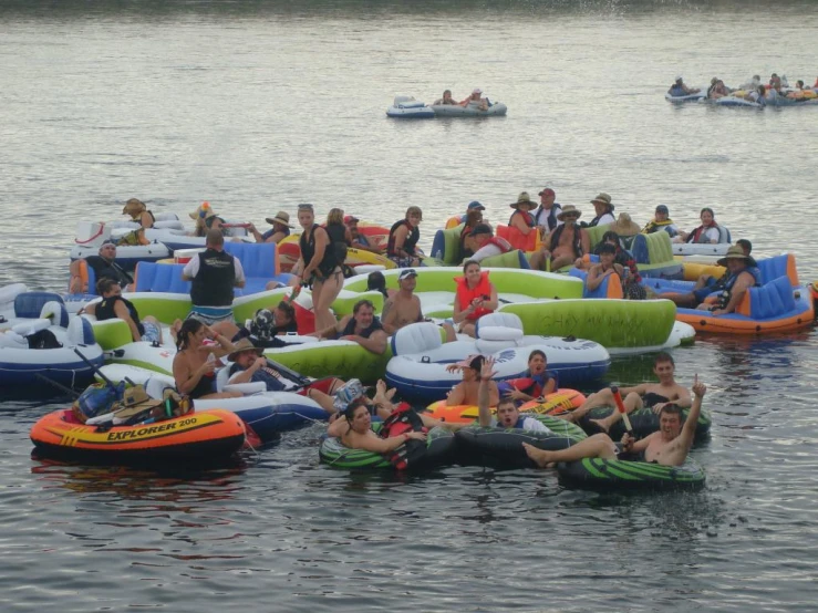 group of people floating down river on giant inflatable tubes