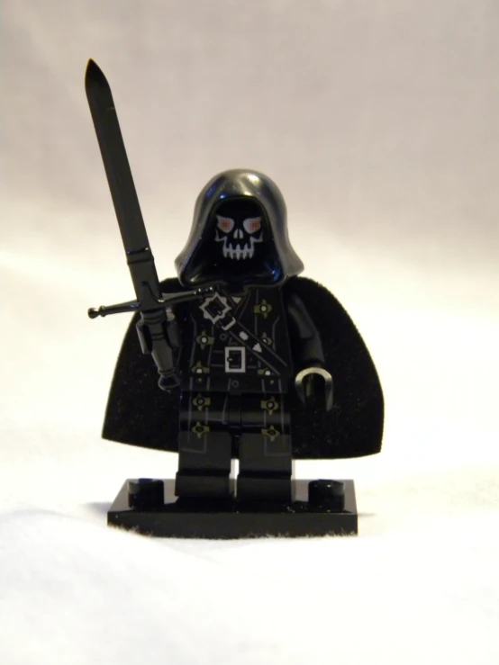 a lego figure with black armor and a sword