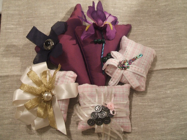 a pillow with several flowers and pins