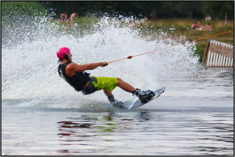 a man riding water skis while being pulled on rope