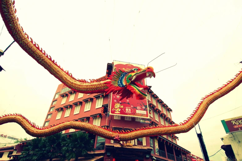 large chinese snake statue displayed in front of building