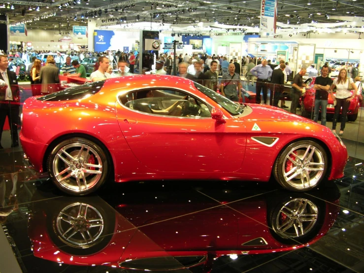 a sport car sitting on display at a trade show