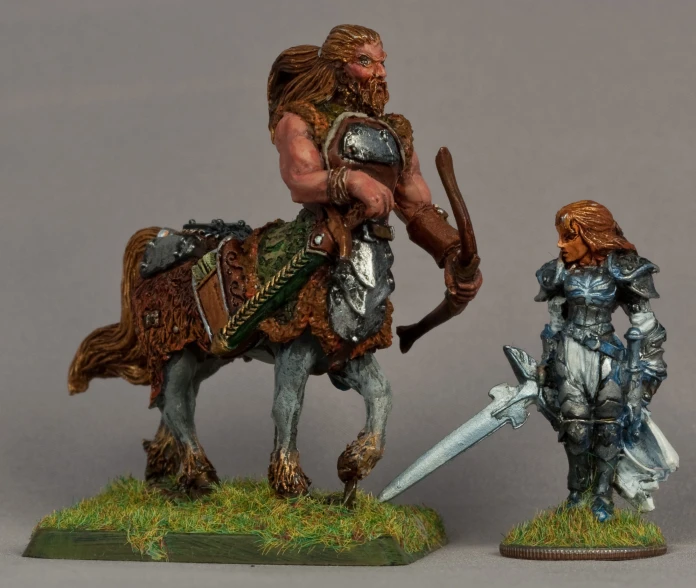 two miniature figures, one wearing armor and the other carrying a sword