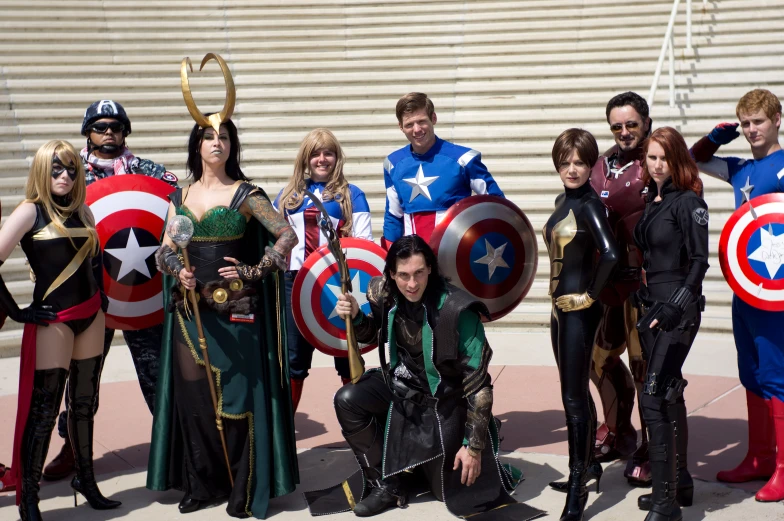 several people dressed as captain america in front of some steps