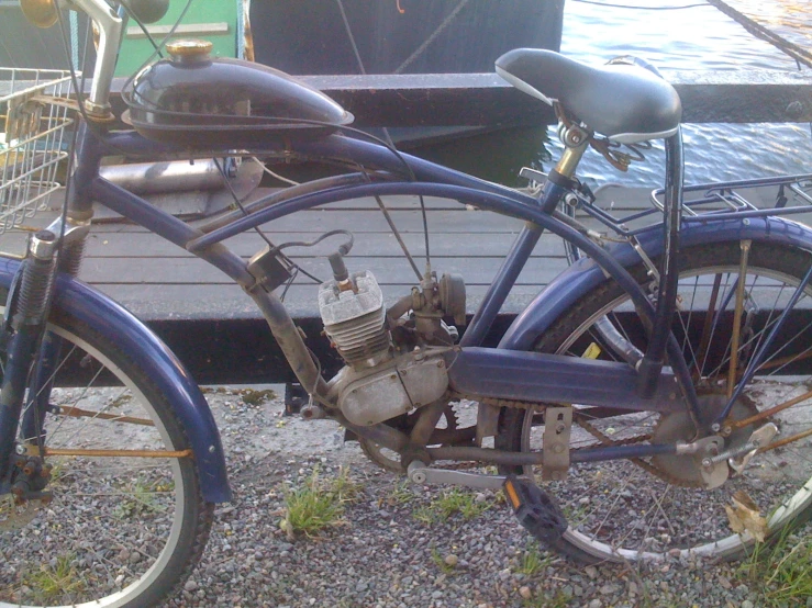 an antique motorcycle parked in front of a dock