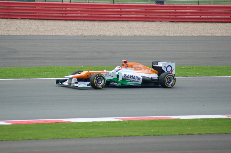 a man driving a racing car down a race track