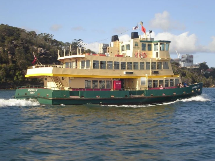 a green and yellow boat in the water