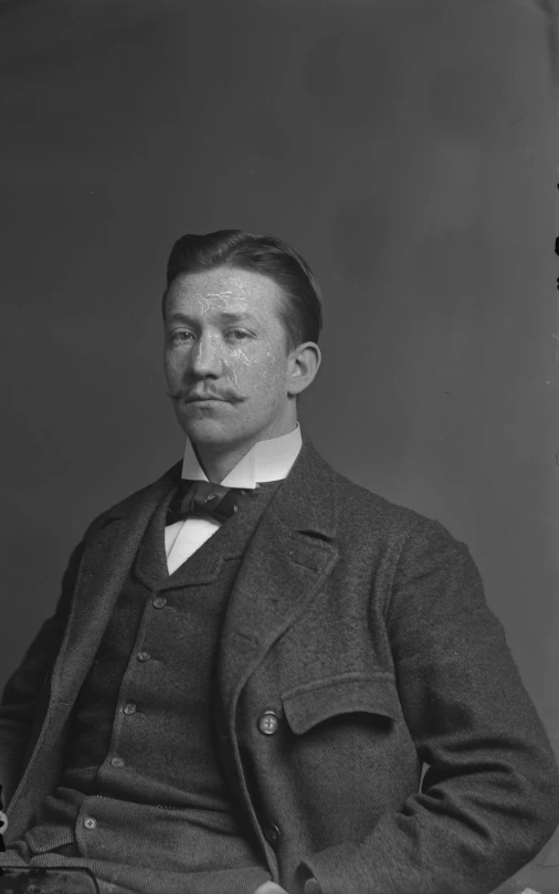 a black and white po of a man in a suit