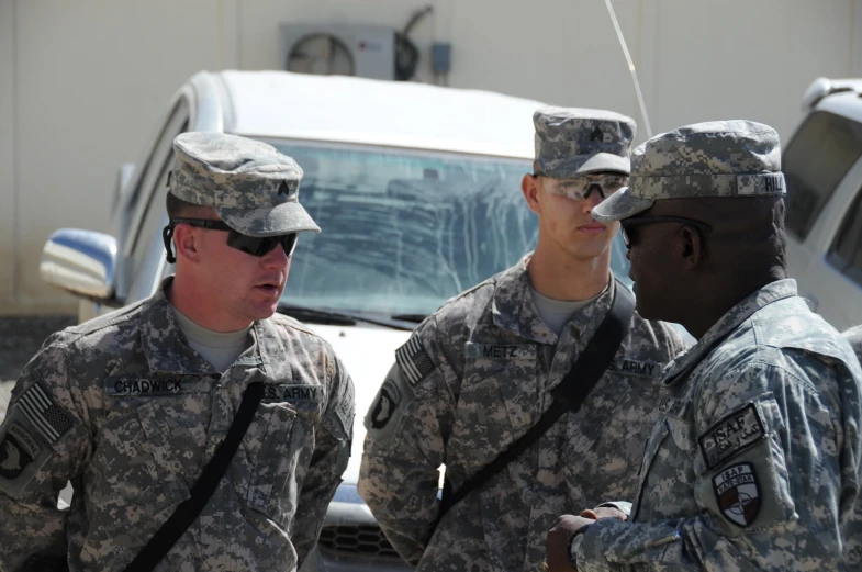 two military men and one man holding a string