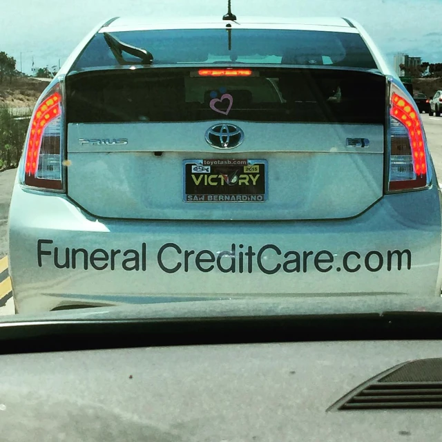 a car with an ad for the funeral credit card