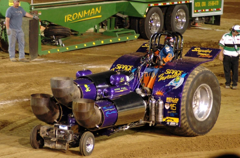 a purple car is on the ground during a race