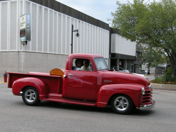 a red truck parked in front of a building