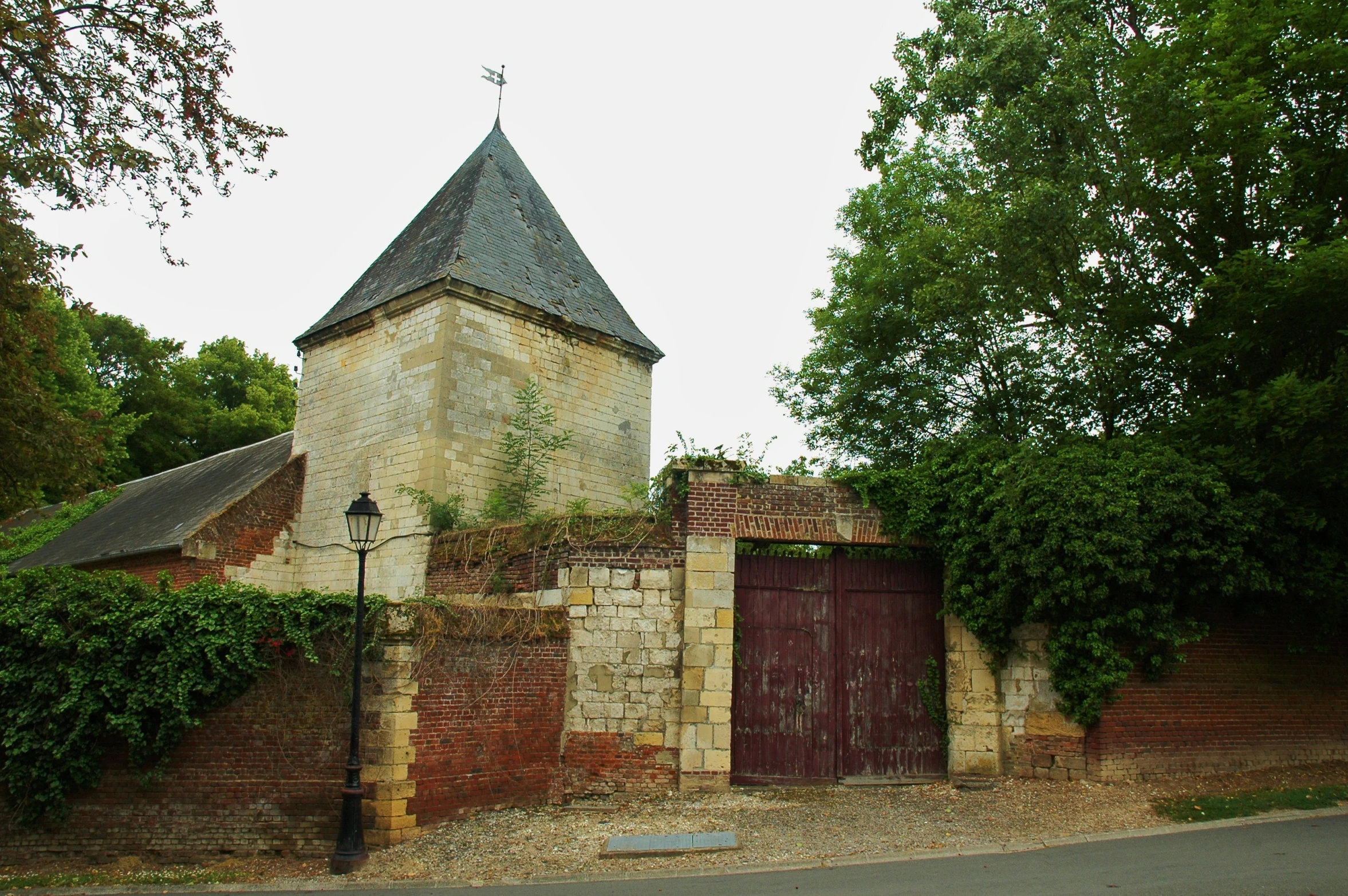 an old church sits next to a tree