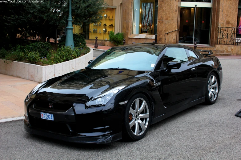 black sport car sitting on the side of the road