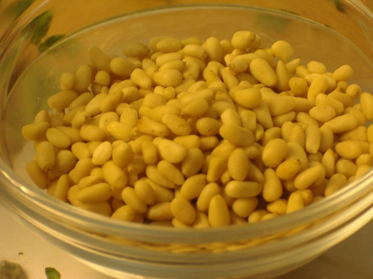 a bowl filled with green and yellow seeds