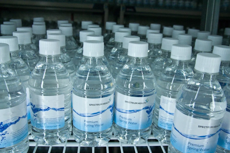 a shelf full of bottles filled with water