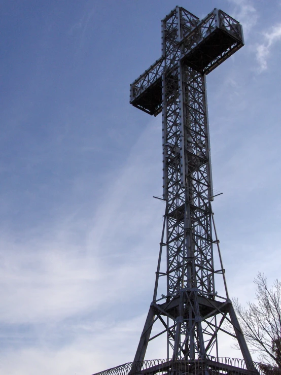 the top of a metal structure with an ornate cross on it