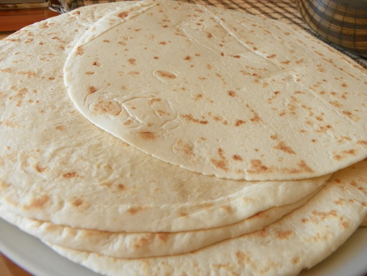 flat bread on a plate sitting on the table