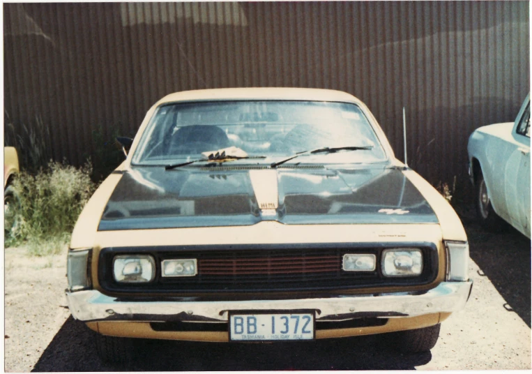 this car is parked outside near a fence