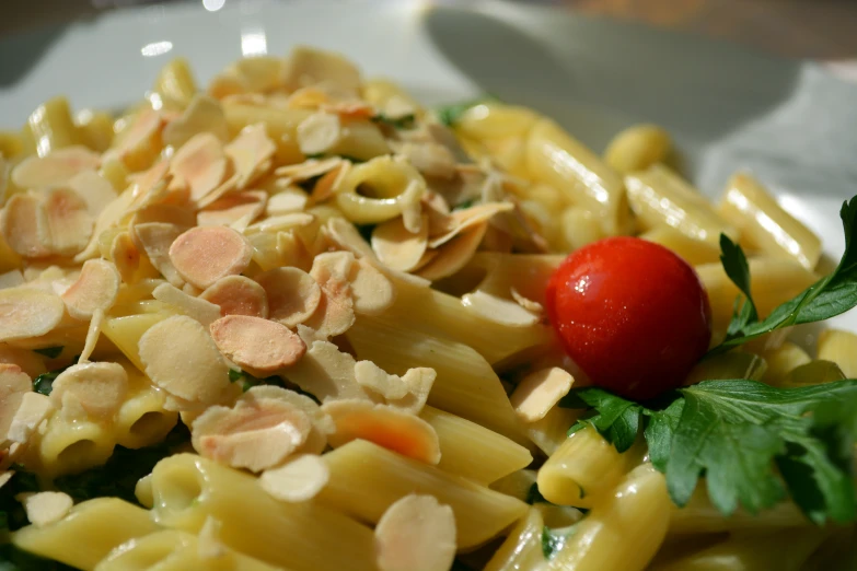 pasta and cheese with some cherry tomato on it