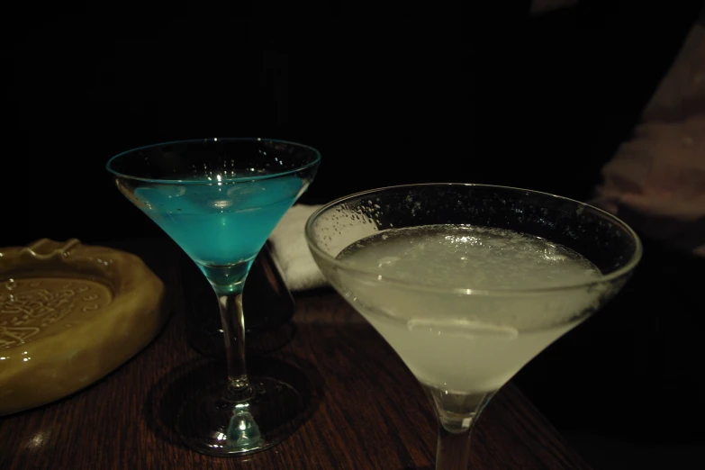 two martinis sitting on top of a table