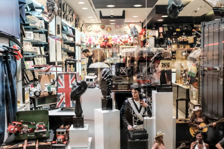 a music store with various guitars, and mannequins