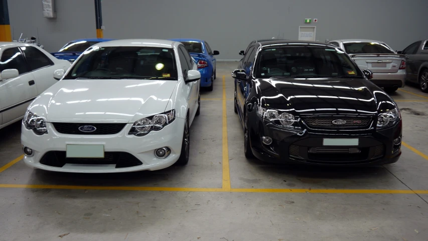 several cars parked side by side in a building