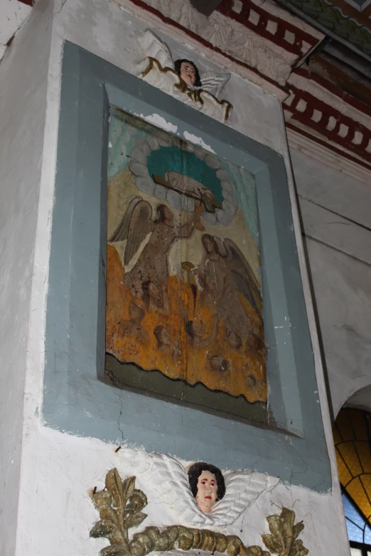 some paintings above the doorway door of a building