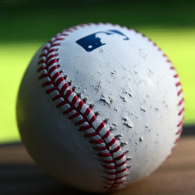 a baseball that has been cleaned and sitting on the floor