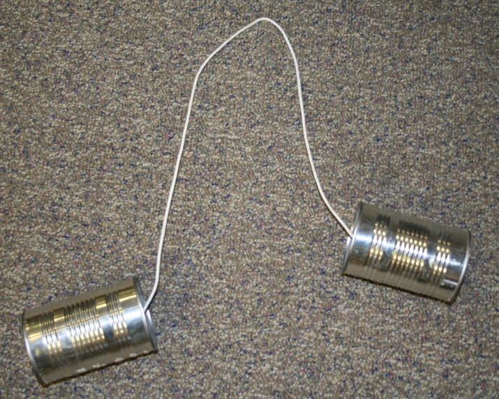 a couple of metal cups sitting on top of a carpet