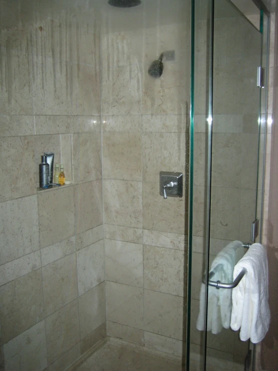 a bathroom with white towels hanging on a rack