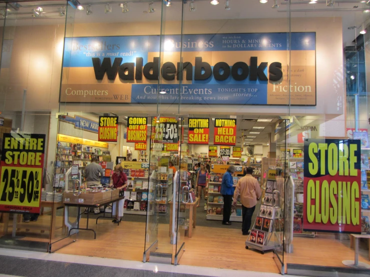 a shop front with people walking through the stores