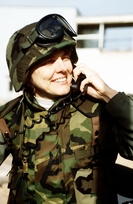 a woman in a military outfit is talking on her phone