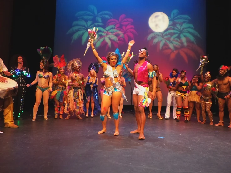 a group of people dancing on stage at a competition