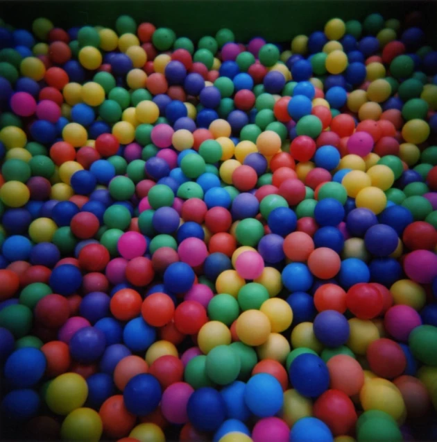 many small multicolored balls are on the floor