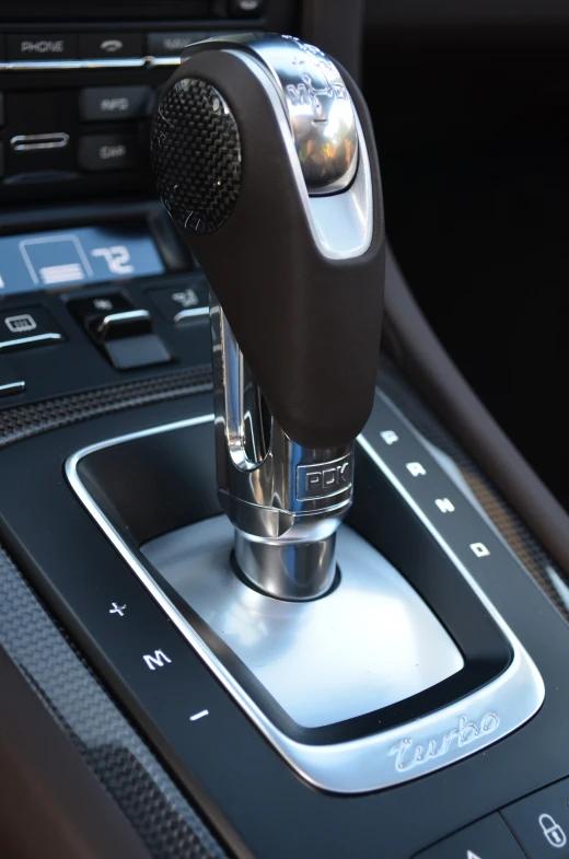 a black automatic shift stick with the steering wheel turned on