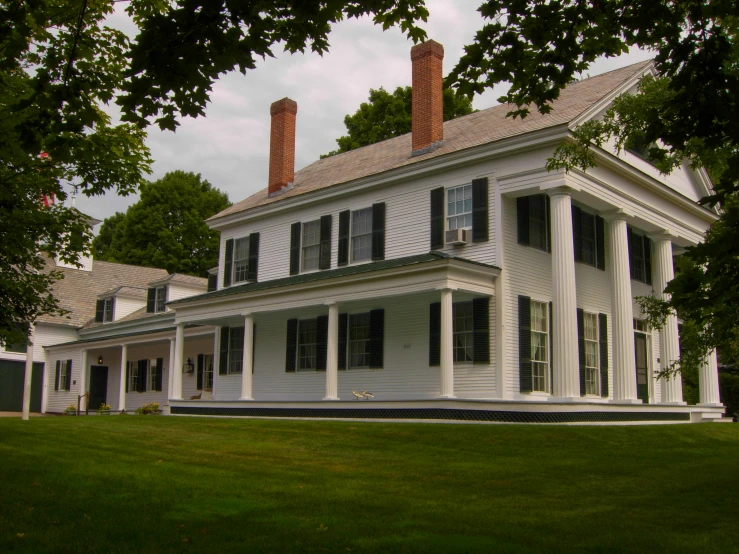 a large white house with lots of trees