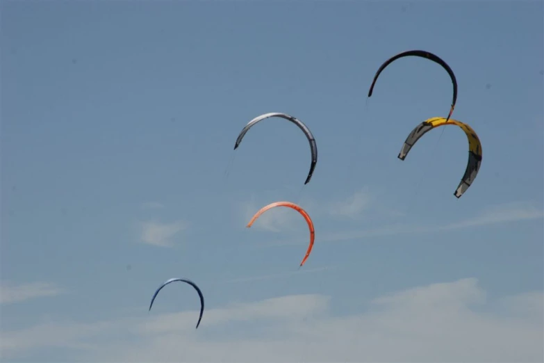 four kites in the sky with blue skies