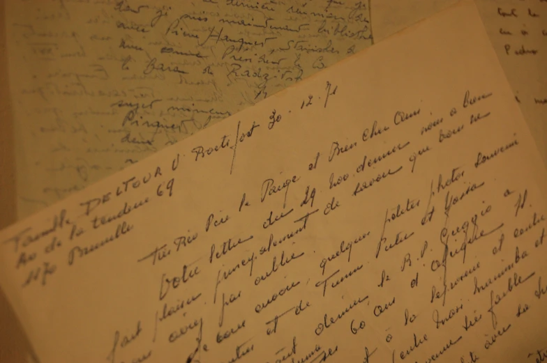 there are two old papers written in cursive writing