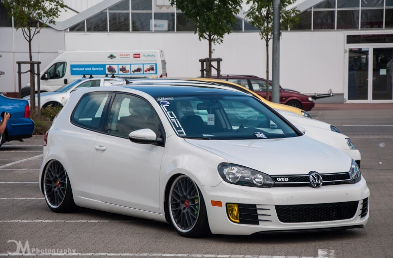 a car sits parked in an outdoor parking lot