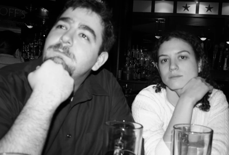 a man and woman sitting at a table together