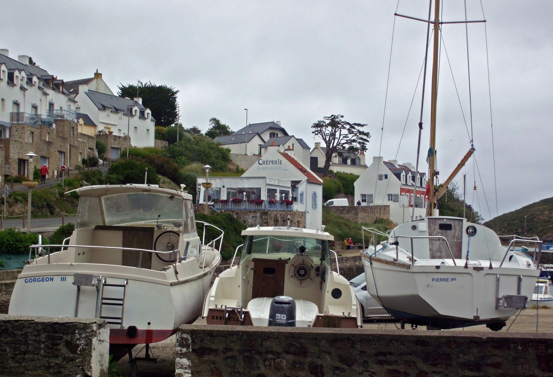 two boats sitting in the water next to the docks