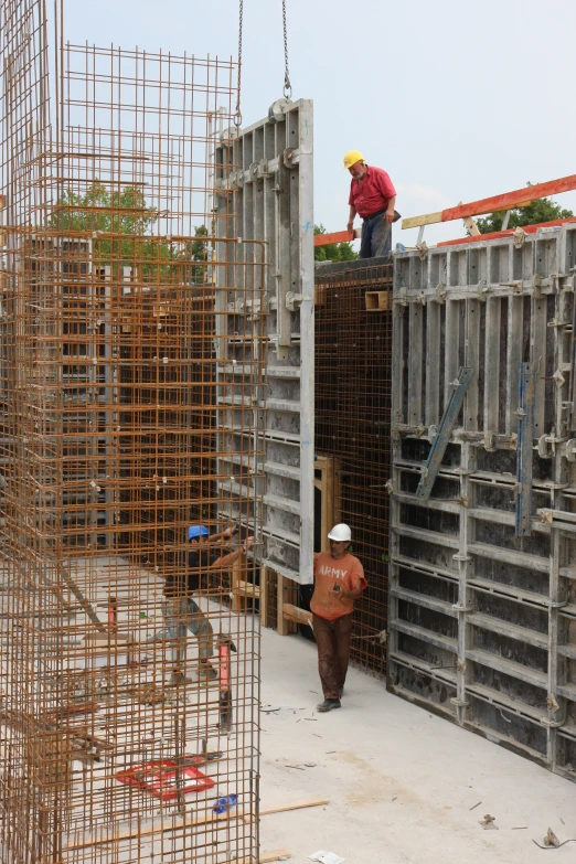 construction workers working on the roof of a building